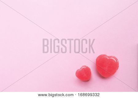 two Pink Valentine's day heart shape candy on empty pastel pink paper background. Love Concept. top view. Minimalism colorful hipster style.