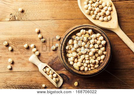 Portion of Chick Peas in wooden bowl with spoon top view