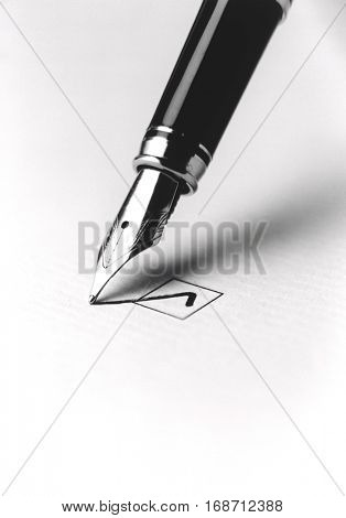 Tip of a Pen Checking a Box