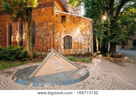 Riga, Latvia - July 1, 2016: Pyramidal Monument To Barricades And Perished People On January 20 1991 On Jekaba Street. Political Confrontations Between Latvian And Soviet Forces. St. James Cathedral Behind.