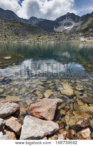Stones in the water and reflection of Musalenski lakes,  Rila mountain, Bulgaria