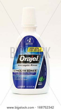 New York January 25 2017: A bottle of Orajel antiseptic mouth rinse stands against white background.