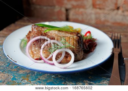 Grilled pork ribs on old peeled painted surface - hearty dish