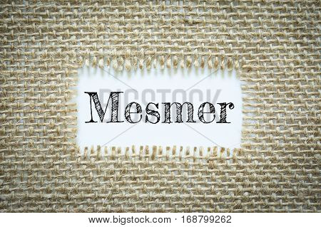 Text Mesmer on paper white has Cotton yarn background you can apply to your product.