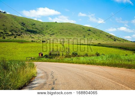 Country road through meadows somewhere in South Africa