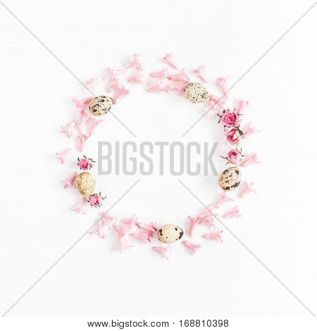 Easter wreath made of quail eggs and flowers. Easter frame. Flat lay top view