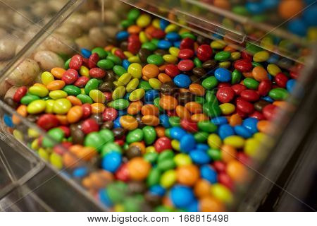food, junk-food, confectionery and unhealthy eating concept - close up of multicolored dragee candies in box