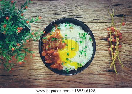 Rice With Fried Egg And Tomato Sauce On Table Vintage Wooden Surface Top View
