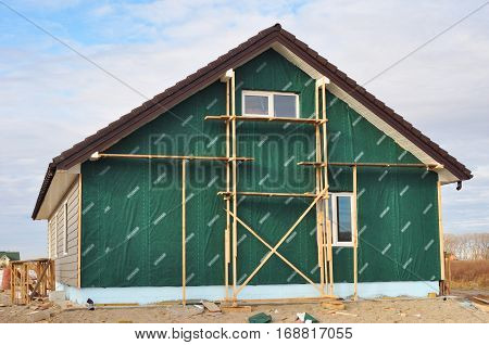 KIEV UKRAINE - JANUARY 8 2017: Building New House with Plastic Siding and Insulation Membrane on House Wall.
