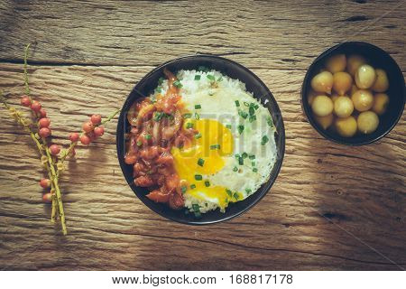 Rice With Fried Egg And Tomato Sauce On Table Vintage Wooden Surface Top View