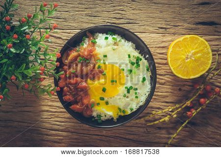 Rice With Fried Egg And Tomato Sauce On Table Vintage Wooden Surface Top View