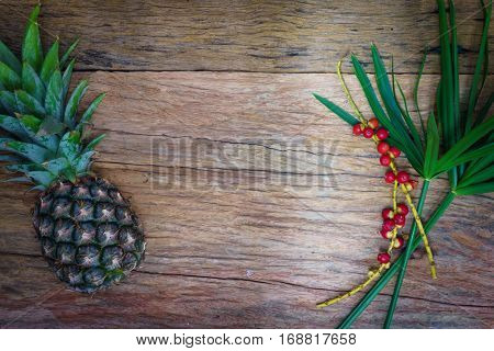 Pineapple, Raw Coffee Beans And Grass. On Wooden Rustic Background Top View Borde.
