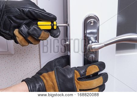 handyman repair the door lock in the room