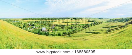 Countryside in Russia fields and cottage. Panorama.