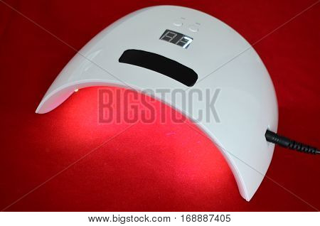 Nail gel salon. Beautiful woman hand and lamp UV  for nails UV with timer