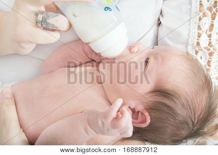 Joy And Happiness Of Bottle Feeding Baby In Mother's Arms