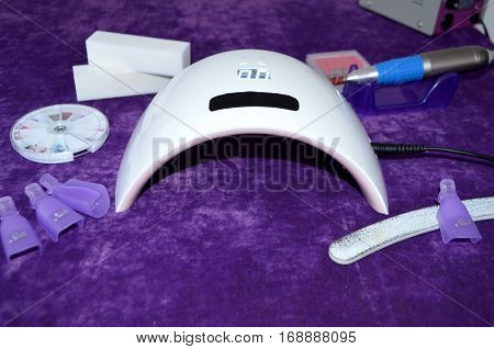 Nail gel salon. Beautiful woman hand and lamp UV  for nails UV with timer