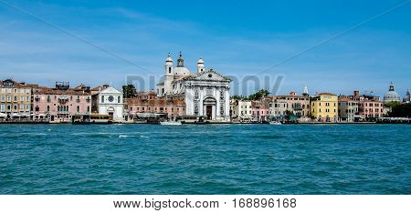 A view of the Saint Maria of Gesuati church on the grand canal in Venice, Italy centered in a seafront of colors and varied architecture