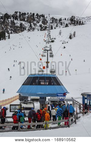 HINTERTUX, AUSTRIA - MARCH 29, 2015: The ski lift Nordhangbahn at the Horberg mountain in Tyrol Austria with people in the queue for a lift to the mountaintop