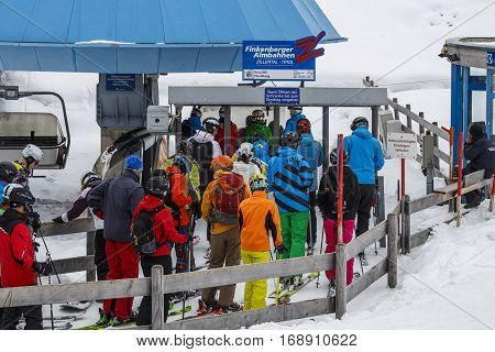 HINTERTUX, AUSTRIA - MARCH 29, 2015: The ski lift Nordhangbahn at the Horberg mountain in Tyrol Austria with people in the queue for a lift to the mountaintop