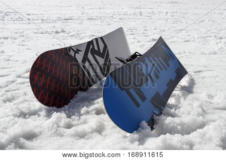 HINTERTUX, AUSTRIA - MARCH 29, 2015: Two snowboards lying in powder snow with a ski lift in the background the picture was taken at Rastkogel in Tyrol Austria