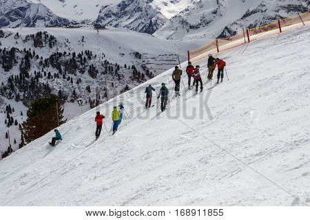 HINTERTUX, AUSTRIA - MARCH 29, 2015: Group of people waiting prior downhill skiing on a black piste at the Horberg mountain in Tyrol Austria