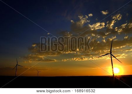 Power generated by wind with winmill blowing sky clouds sunset sunrise