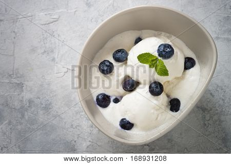 Vanilla Ice Cream with blueberries in bowl Summer refreshing dessert. Top view