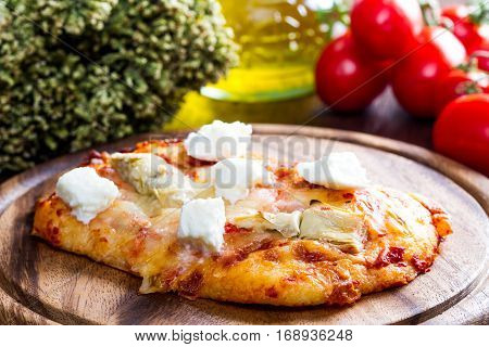 Pizza With Artichoke And Oregan On Wood