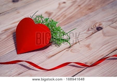 Hearts flowers ribbons on a wooden light background