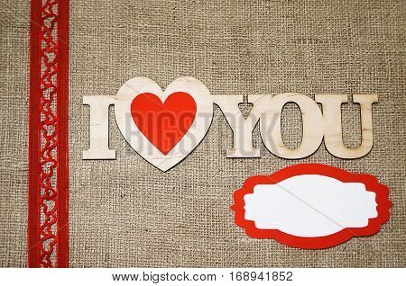 Hearts flowers ribbons on a wooden light background
