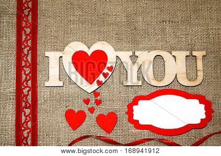 Hearts flowers ribbons on a wooden light background