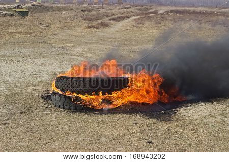 burning tire at tactical field in spring