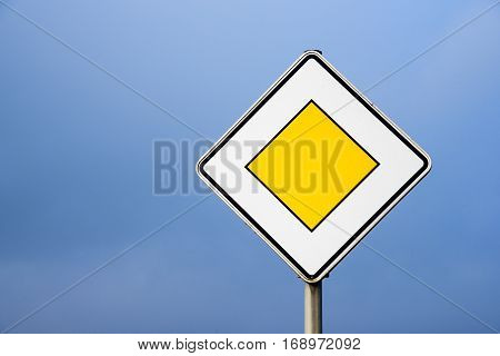 Priority road european traffic sign against the clear blue sky copy space