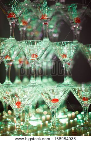 Pyramid of holiday shiny wineglasses with wine or champagne