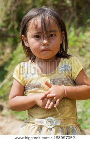 Ha Giang, Vietnam - Sep 22, 2013: Portrait of Hmong little girl child in front of her house