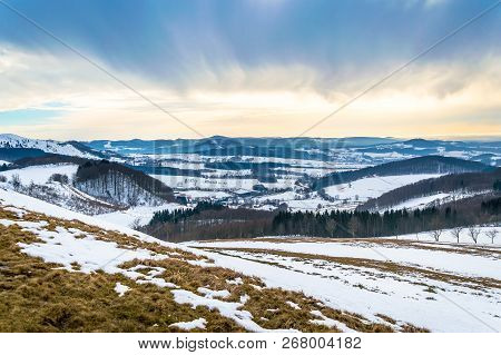 Winter Landscape With Snow And Dramatic Sky In Low Mountains