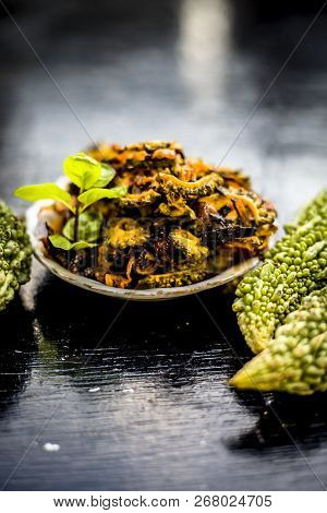Popular Dish For Serving In Lunch I.e. Bitter Gourd With Spices And Vegetables On Wooden Surface In
