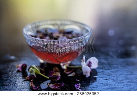 Close Up Of Holy Rose Water Or Gulab Jal Or Gulab Ka Pani In A Glass Bowl On Wooden Surface With Som