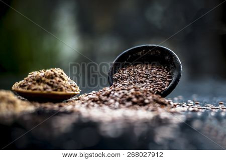 Close Up Of Ayurvedic Herb Alsi Or Adsi Or Flax Seed In A Black Colored Clay Bowl With Its Powder On