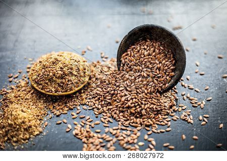 Close Up Of Ayurvedic Herb Alsi Or Adsi Or Flax Seed In A Black Colored Clay Bowl With Its Powder On