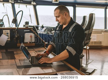 Marine Navigational Officer Is Using Laptop Or Notebook At Sea