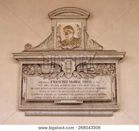 Milan, Italy-09 May 2018: Memorial Plaque On The Wall Of The Basilica Of Santambrogio. In The Church