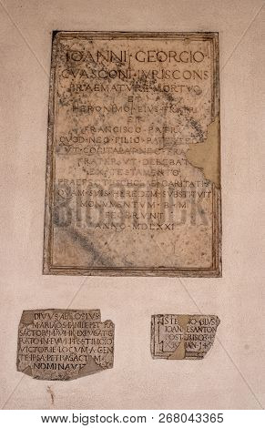Milan, Italy-09 May 2018: Memorial Plaque On The Wall Of The Basilica Of Santambrogio. In The Church