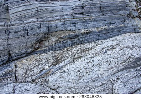 Gray Stone Wall With Stripes Of Geological Processes. Greece