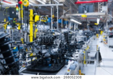 Blurred Background Internal Parts Of Car. Defocused Image Of Car Suspension. Car Factory Background