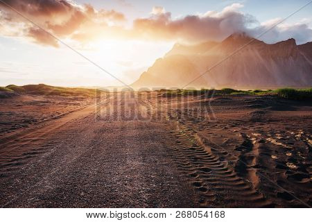 Fantastic Sunset Of The Mountains And Volcanic Lava Sand Dunes To The Beach In Stokksness. The Conce