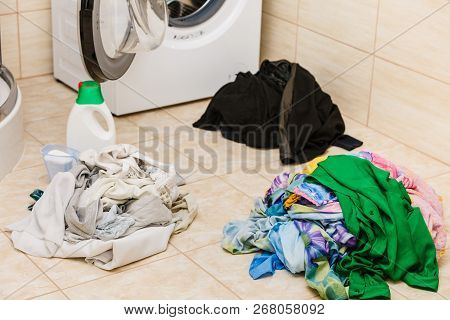 Washing Powder Detergent And Measuring Cup Next To Machine In Bathroom. Household Duties, Clothes La