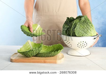 Woman With Fresh Savoy Cabbage At Table