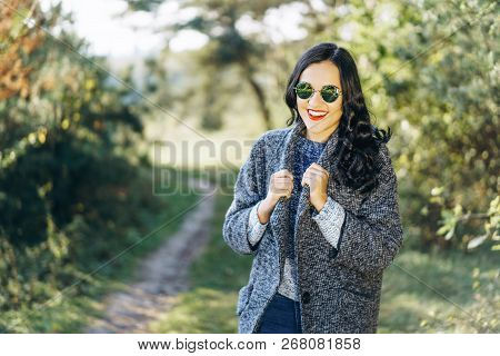 Pretty Long Hair Bruntte Girl Walking In The Autumn Forest.